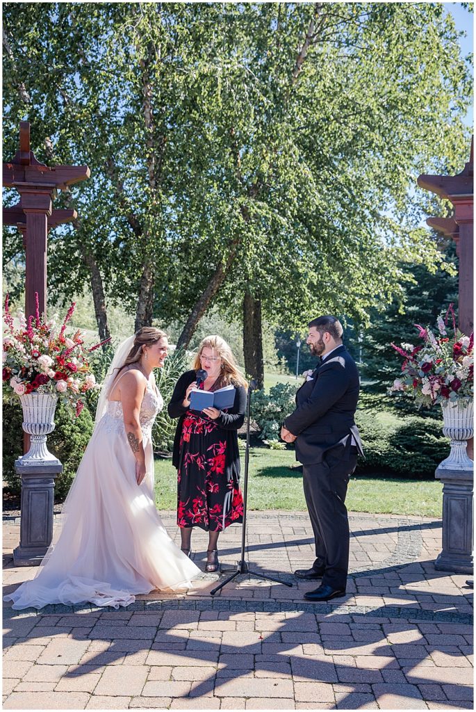 Atkinson Country Club wedding ceremony at the trellis in the fall